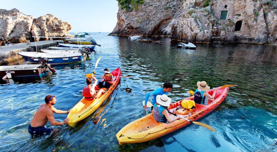 Guides helping people get off with their sea kayaks in Dubrovnik