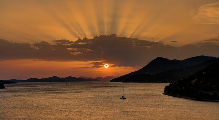 The sea and the sailing boat in Dubrovnik at sunset